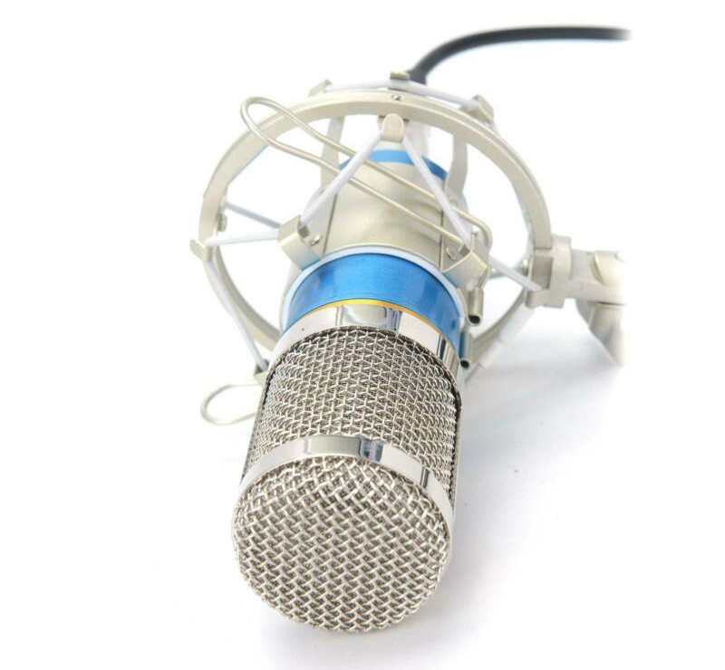 A microphone placed on a flat surface shows the microphone body and wire.